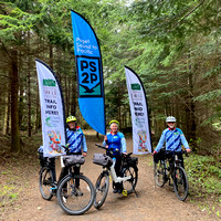 Cyclists with PS2P & ODT feather flags